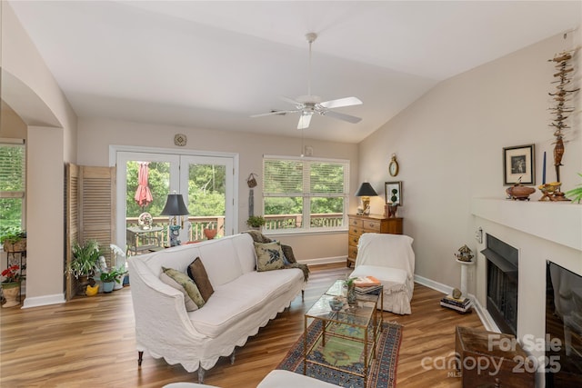 73 Ridgetop Cir Unit 302, Brevard, NC 28712 - living room featuring a fireplace, ceiling fan, wood finished floors, and vaulted ceiling