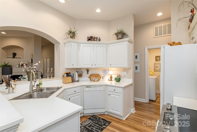 73 Ridgetop Cir Unit 302, Brevard, NC 28712 - kitchen featuring dishwasher, light wood-type flooring, white cabinetry, arched walkways, and light countertops