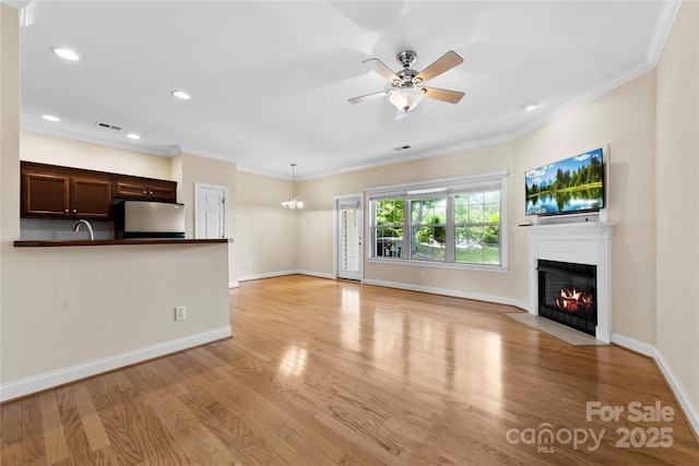 2765 Clover Rd NW, Concord, NC 28027 - unfurnished living room with a fireplace with flush hearth, light wood-style flooring, recessed lighting, a ceiling fan, and ornamental molding