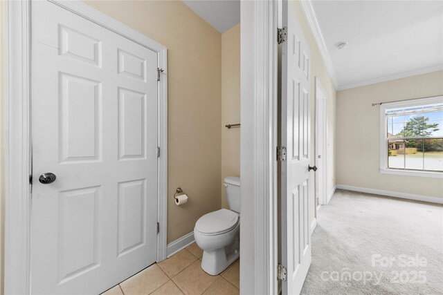 2765 Clover Rd NW, Concord, NC 28027 - bathroom featuring toilet, baseboards, and ornamental molding