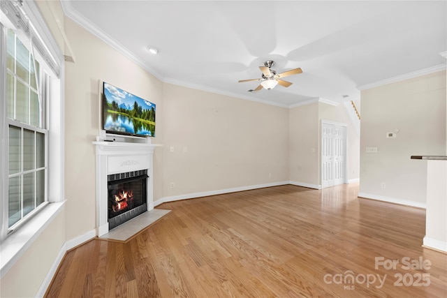 2765 Clover Rd NW, Concord, NC 28027 - unfurnished living room with a fireplace with flush hearth, ceiling fan, wood finished floors, ornamental molding, and baseboards