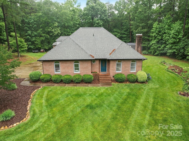 733 Killian Rd, Stanley, NC 28164 - view of front of home featuring a chimney, a shingled roof, a front lawn, and brick siding