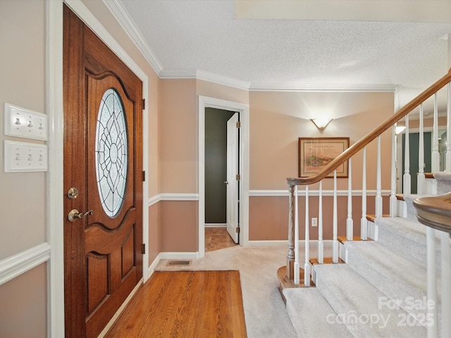 733 Killian Rd, Stanley, NC 28164 - carpeted foyer entrance with stairs, crown molding, a textured ceiling, and baseboards