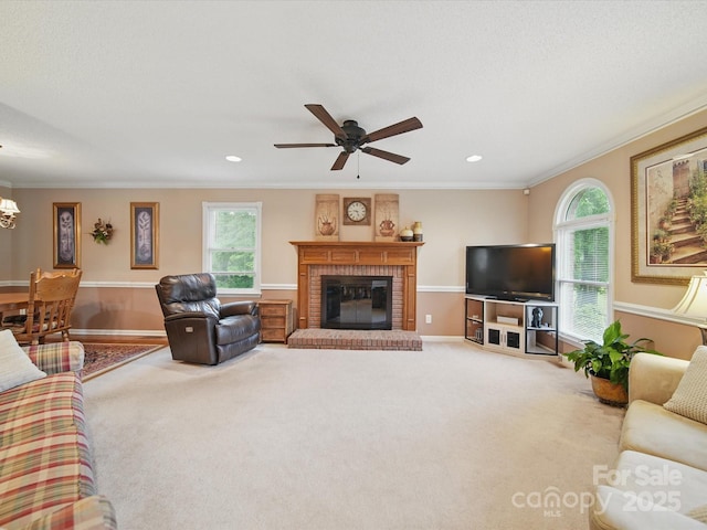 733 Killian Rd, Stanley, NC 28164 - living area with ornamental molding, a brick fireplace, a chandelier, carpet flooring, and a ceiling fan
