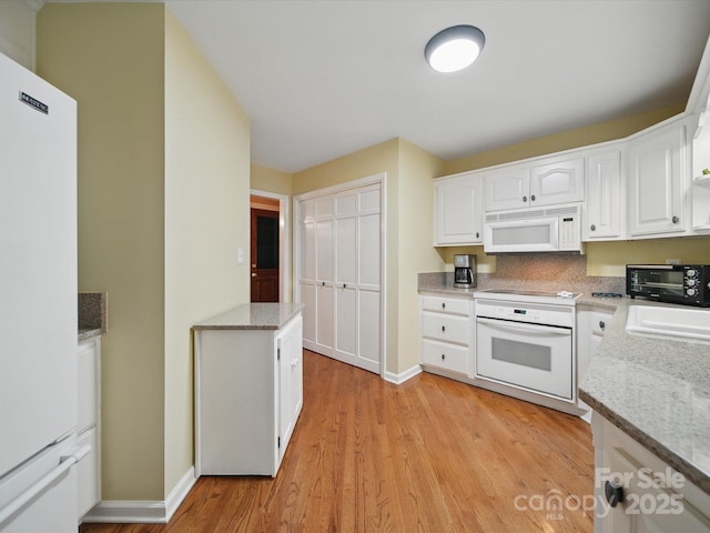 733 Killian Rd, Stanley, NC 28164 - kitchen featuring white appliances, white cabinets, and baseboards