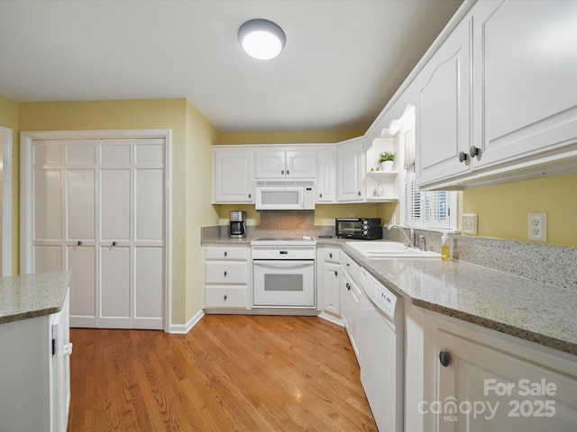 733 Killian Rd, Stanley, NC 28164 - kitchen featuring white appliances, a sink, light wood-style flooring, and white cabinets