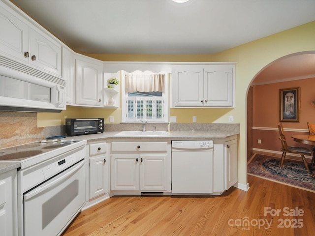 733 Killian Rd, Stanley, NC 28164 - kitchen featuring white appliances, a sink, arched walkways, and white cabinetry