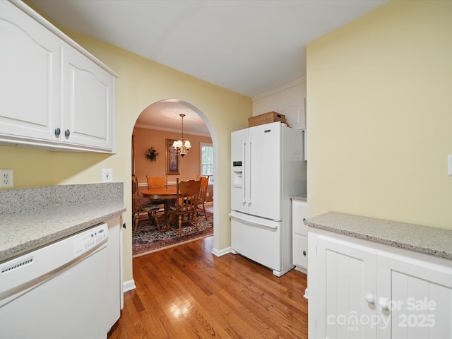 733 Killian Rd, Stanley, NC 28164 - kitchen featuring white appliances, arched walkways, a chandelier, light wood finished floors, and white cabinetry