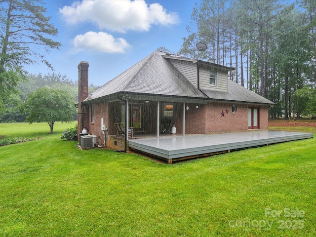 733 Killian Rd, Stanley, NC 28164 - back of property with central air condition unit, a deck, brick siding, a lawn, and a chimney