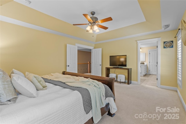 1336 Dobson Dr, Waxhaw, NC 28173 - bedroom with light colored carpet, a tray ceiling, a ceiling fan, and connected bathroom