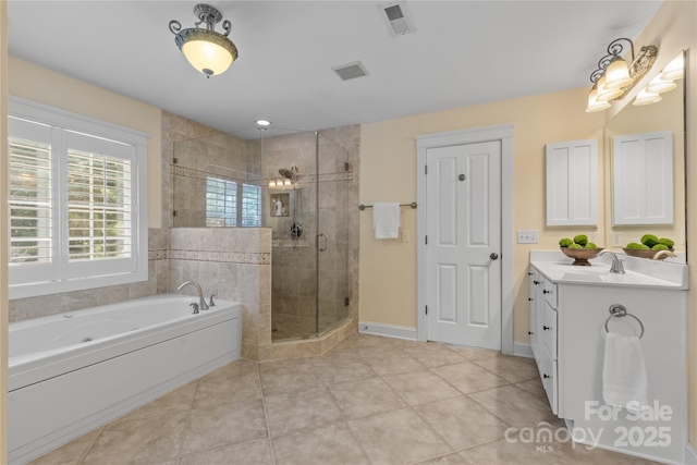 1336 Dobson Dr, Waxhaw, NC 28173 - bathroom featuring vanity, a bath, a stall shower, and tile patterned floors