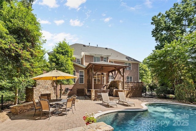 1336 Dobson Dr, Waxhaw, NC 28173 - rear view of property featuring a gazebo, a patio, an outdoor pool, and brick siding