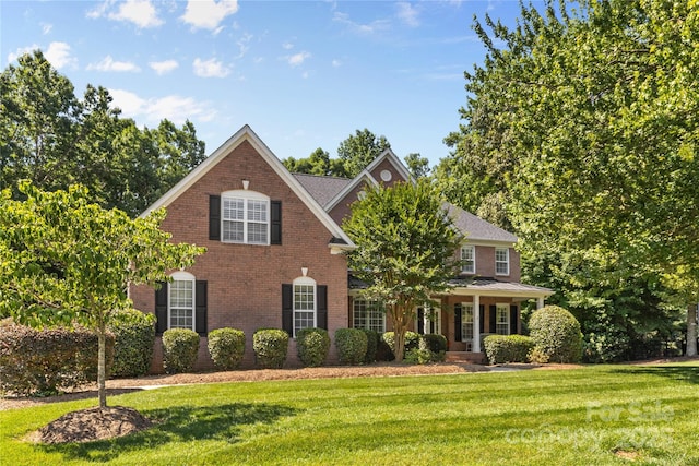 1336 Dobson Dr, Waxhaw, NC 28173 - view of front of home with a front lawn, brick siding, and covered porch