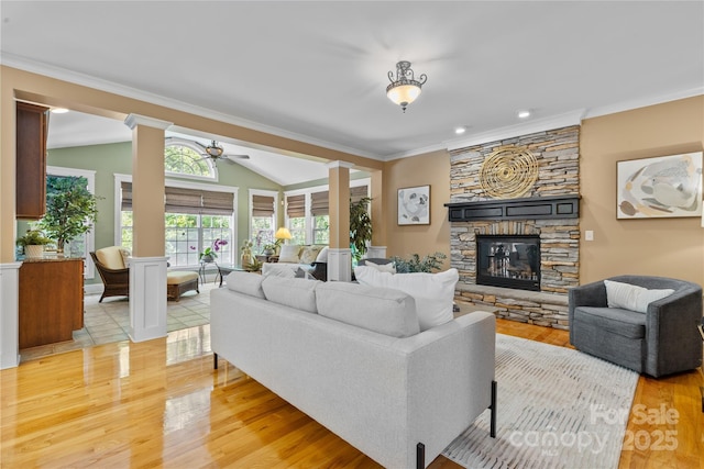 1336 Dobson Dr, Waxhaw, NC 28173 - living area with decorative columns, a stone fireplace, ceiling fan, crown molding, and light wood-type flooring