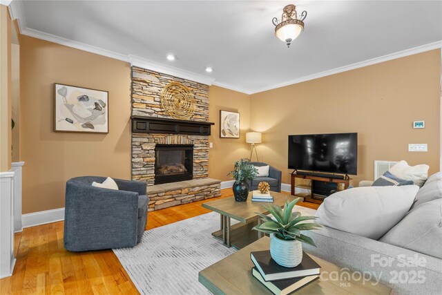 1336 Dobson Dr, Waxhaw, NC 28173 - living room with a fireplace, wood finished floors, ornamental molding, and recessed lighting