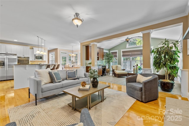 1336 Dobson Dr, Waxhaw, NC 28173 - living area with decorative columns, ornamental molding, light wood-style floors, a chandelier, and ceiling fan