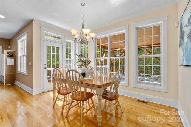 1336 Dobson Dr, Waxhaw, NC 28173 - dining area featuring a chandelier, light wood-type flooring, and ornamental molding