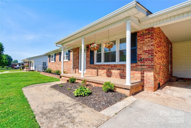 3413 Fallston Rd, Shelby, NC 28150 - view of side of home with brick siding, covered porch, a lawn, and central AC unit