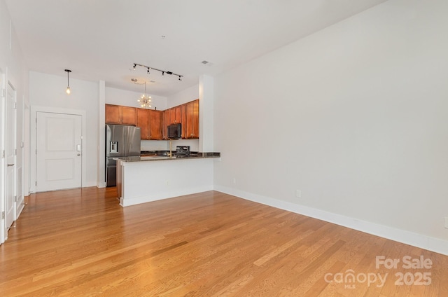 3271 Noda Blvd, Charlotte, NC 28205 - kitchen with stainless steel fridge with ice dispenser, black microwave, dark countertops, a chandelier, and light wood finished floors
