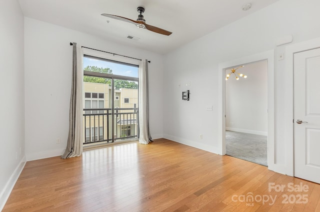 3271 Noda Blvd, Charlotte, NC 28205 - empty room with ceiling fan, light wood finished floors, a smoke detector, and a chandelier