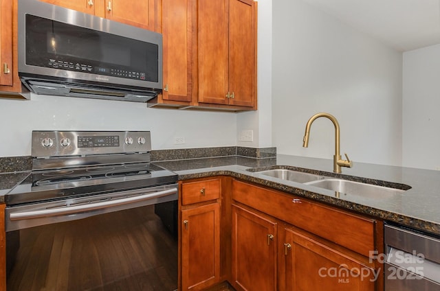3271 Noda Blvd, Charlotte, NC 28205 - kitchen featuring stainless steel appliances, dark stone countertops, and brown cabinetry