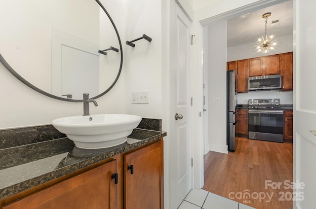 3271 Noda Blvd, Charlotte, NC 28205 - bathroom with vanity, wood finished floors, and a chandelier