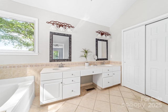 12712 Hollyhock Ln, Huntersville, NC 28078 - bathroom featuring tile patterned flooring, double vanity, lofted ceiling, and a garden tub