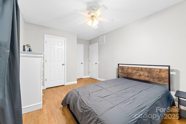 12712 Hollyhock Ln, Huntersville, NC 28078 - bedroom featuring wood finished floors, a ceiling fan, and a textured ceiling