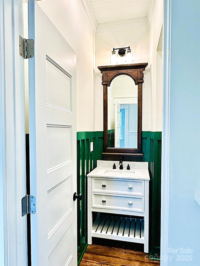 604 Ferguson Ridge Rd, Gastonia, NC 28052 - bathroom with a wainscoted wall, vanity, crown molding, wood finished floors, and a decorative wall