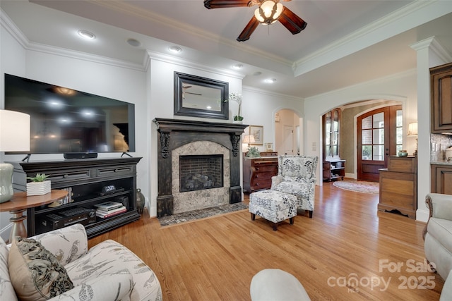 103 3rd St SW, Catawba, NC 28609 - living area with arched walkways, a ceiling fan, a high end fireplace, light wood finished floors, and ornamental molding