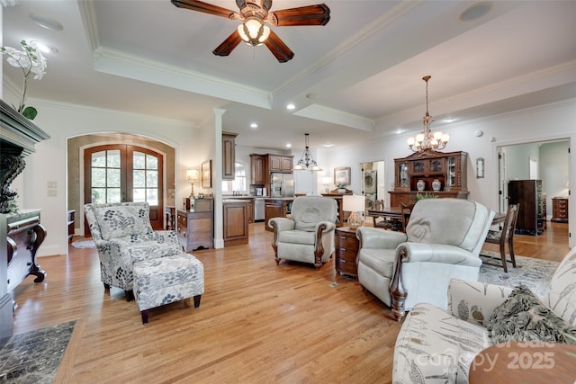 103 3rd St SW, Catawba, NC 28609 - living room featuring a chandelier, ceiling fan, crown molding, light wood-style floors, and arched walkways