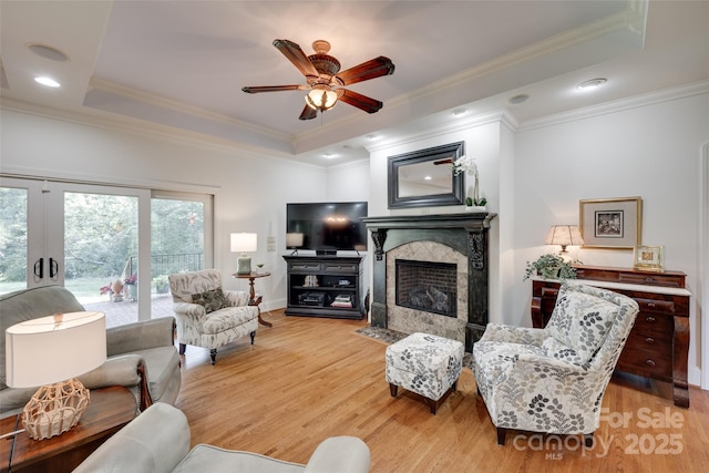 103 3rd St SW, Catawba, NC 28609 - living area featuring wood finished floors, ceiling fan, a tray ceiling, a high end fireplace, and ornamental molding