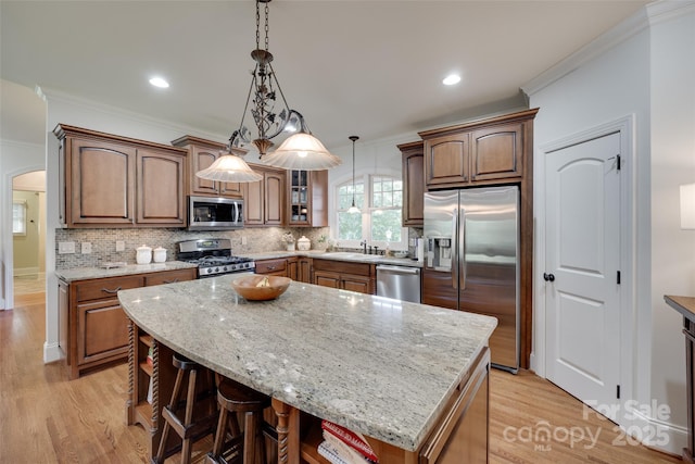 103 3rd St SW, Catawba, NC 28609 - kitchen featuring stainless steel appliances, light wood-type flooring, light stone counters, tasteful backsplash, and ornamental molding