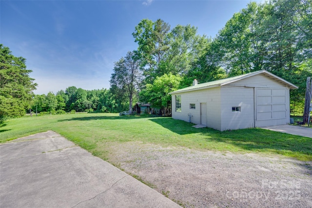 103 3rd St SW, Catawba, NC 28609 - view of grassy yard featuring a detached garage, an outbuilding, and driveway