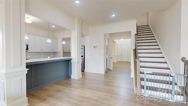 7651 Fenn Way, Fort Mill, SC 29707 - kitchen with light wood finished floors, white cabinets, light countertops, hanging light fixtures, and baseboards