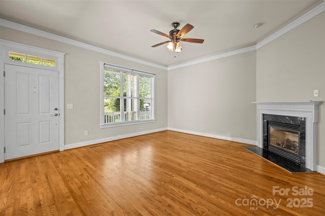 187 Water Oak Dr, Mooresville, NC 28117 - unfurnished living room with healthy amount of natural light, a high end fireplace, light wood-style flooring, ceiling fan, and ornamental molding