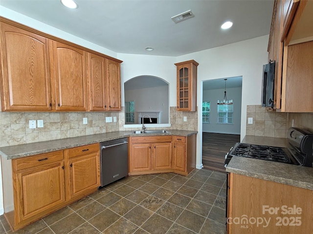509 Settlers Grove Ln, Salisbury, NC 28146 - kitchen with stainless steel dishwasher, decorative backsplash, glass insert cabinets, brown cabinetry, and recessed lighting