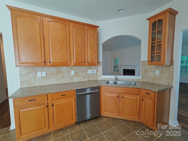 509 Settlers Grove Ln, Salisbury, NC 28146 - kitchen featuring stainless steel dishwasher, glass insert cabinets, tasteful backsplash, arched walkways, and dark tile patterned flooring