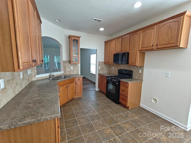 509 Settlers Grove Ln, Salisbury, NC 28146 - kitchen featuring black appliances, backsplash, arched walkways, glass insert cabinets, and recessed lighting