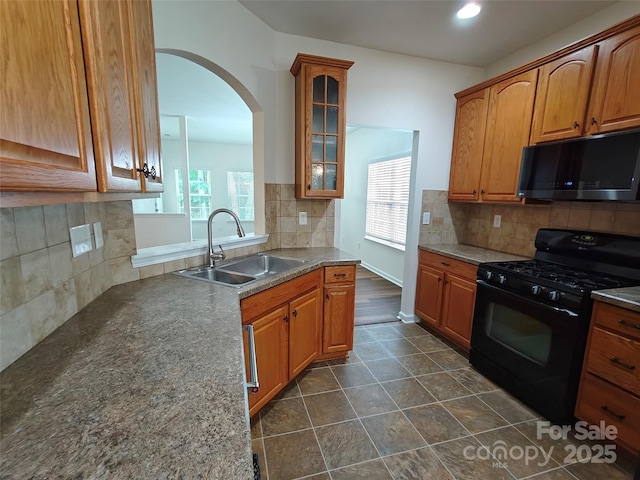 509 Settlers Grove Ln, Salisbury, NC 28146 - kitchen with black appliances, backsplash, glass insert cabinets, arched walkways, and recessed lighting
