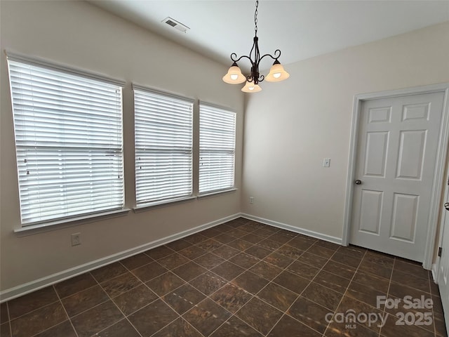 509 Settlers Grove Ln, Salisbury, NC 28146 - empty room with a chandelier, plenty of natural light, and dark tile patterned flooring