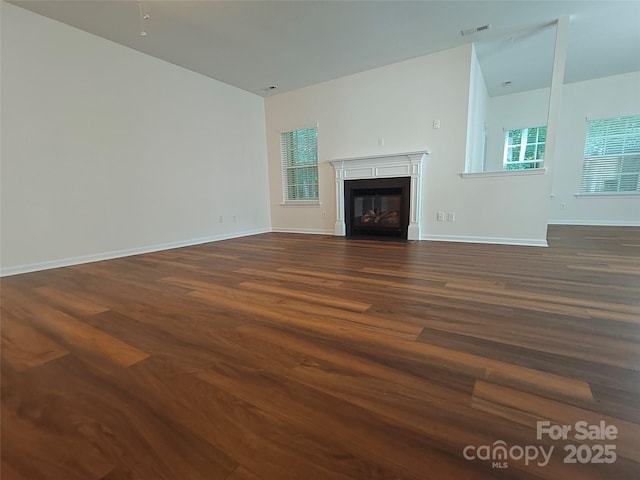 509 Settlers Grove Ln, Salisbury, NC 28146 - unfurnished living room featuring dark wood-style floors and a glass covered fireplace