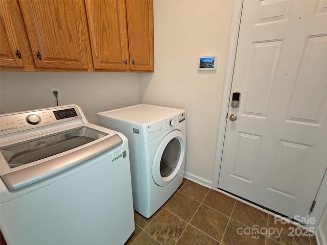 509 Settlers Grove Ln, Salisbury, NC 28146 - laundry room featuring washer and dryer, cabinet space, and dark tile patterned flooring