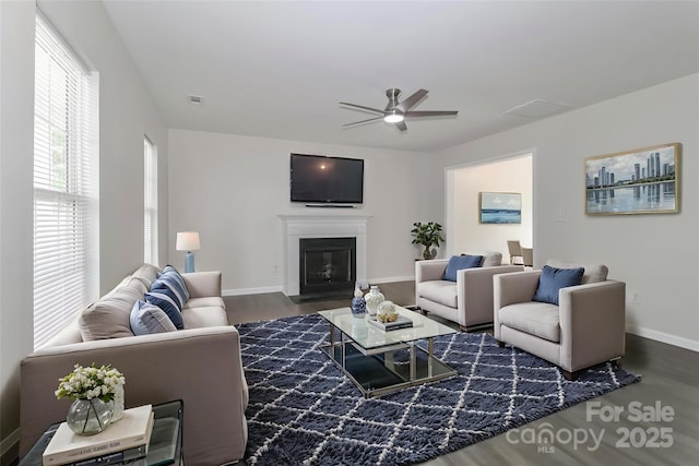 7806 Mcgarry Trl, Charlotte, NC 28214 - living room featuring wood finished floors, a ceiling fan, and a glass covered fireplace