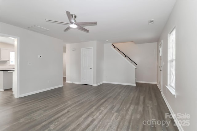 7806 Mcgarry Trl, Charlotte, NC 28214 - unfurnished living room with a ceiling fan, dark wood-style floors, and stairway