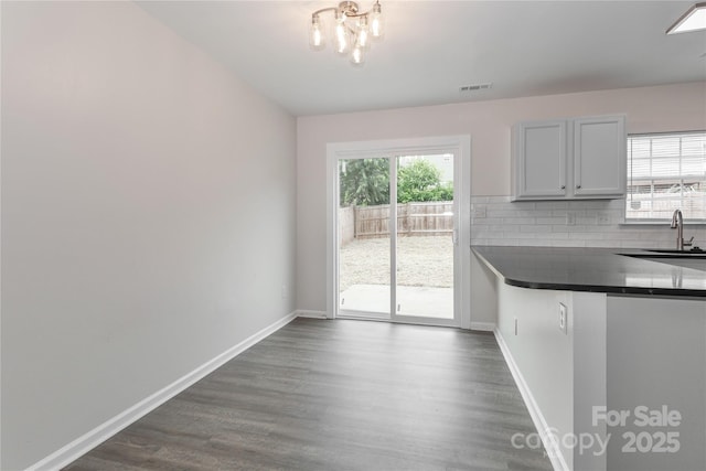 7806 Mcgarry Trl, Charlotte, NC 28214 - unfurnished dining area featuring dark wood finished floors and a chandelier
