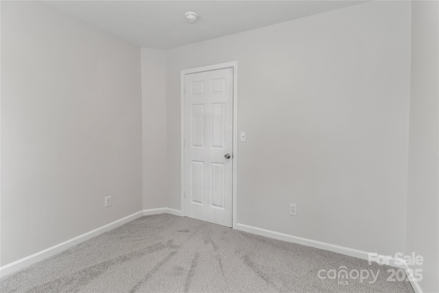 7806 Mcgarry Trl, Charlotte, NC 28214 - carpeted empty room with a smoke detector and baseboards