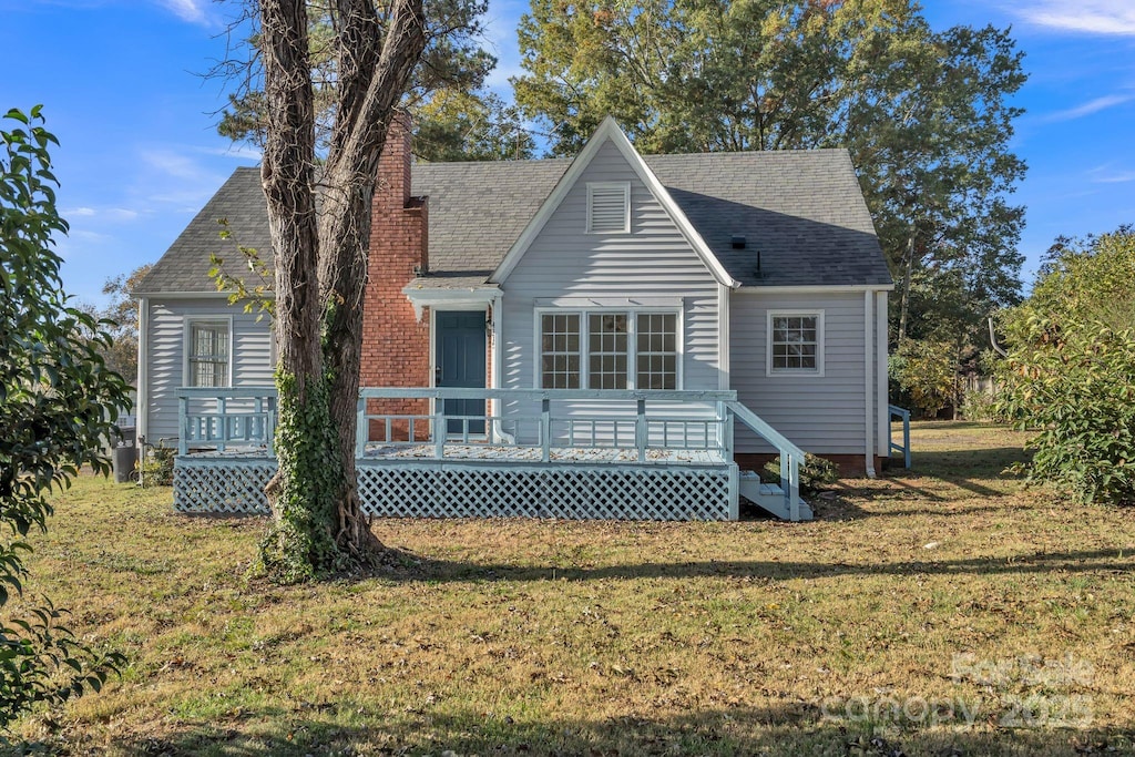 4315 Gibbon Rd, Charlotte, NC 28269 - view of front of home featuring a chimney, a front yard, a wooden deck, and roof with shingles