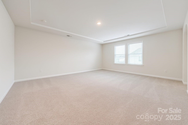 3833 Crossbane St, Kannapolis, NC 28081 - empty room featuring baseboards, light colored carpet, and a raised ceiling