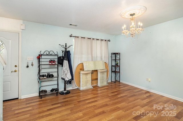 10816 Pointer Ridge Dr, Charlotte, NC 28214 - entryway featuring a chandelier, wood finished floors, and baseboards